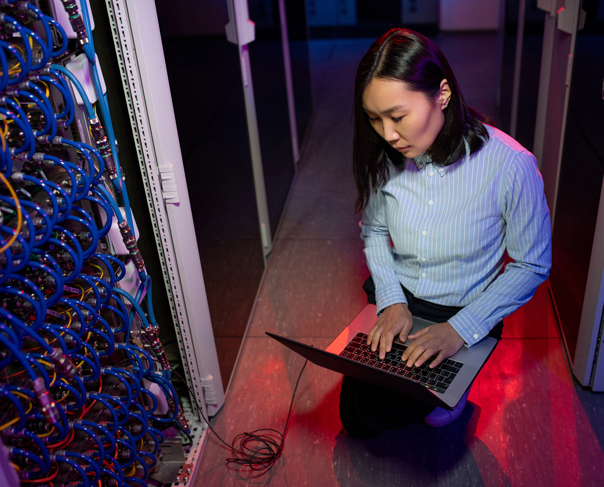 Concentrated Asian IT engineer connecting to server